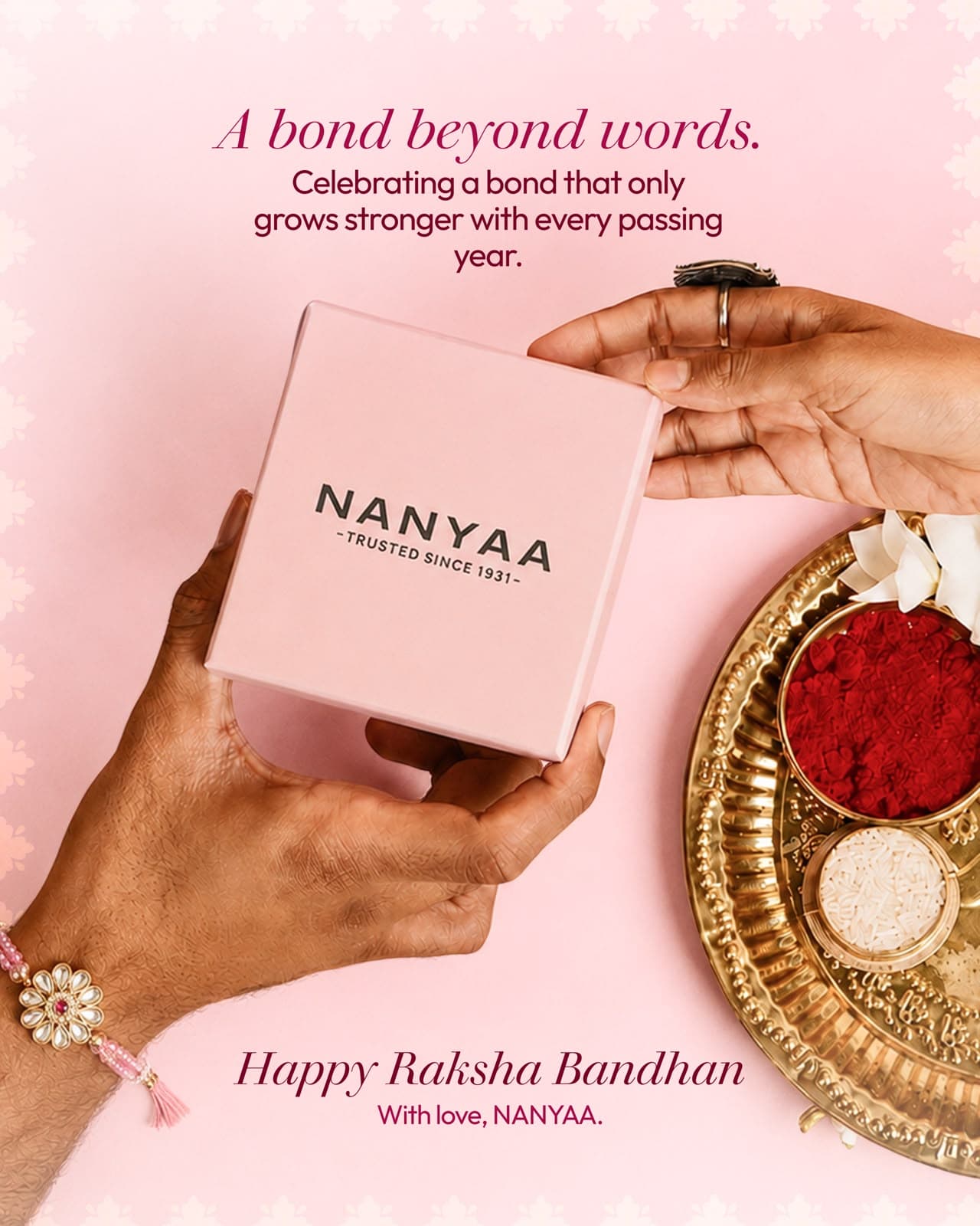 Nanyaa Raksha Bandhan post: hands exchanging a pink Nanyaa gift box